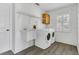 Bright laundry room with modern washer/dryer, sink, upper cabinet and wire shelving at 1731 Knotting Hill Dr, Orlando, FL 32835