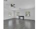 Large living room with hardwood flooring, three windows, and a foosball table at 1731 Knotting Hill Dr, Orlando, FL 32835