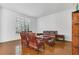Living room with dark hardwood floors, custom furniture, and plantation shutters at 1731 Knotting Hill Dr, Orlando, FL 32835