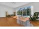 Spacious living room with hardwood floors, large windows, and a view of the screened-in pool at 1731 Knotting Hill Dr, Orlando, FL 32835