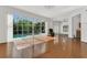 Spacious living room with hardwood floors, large windows, and a view of the screened-in pool at 1731 Knotting Hill Dr, Orlando, FL 32835