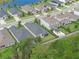 Aerial view showcases the property's placement within a well-maintained neighborhood with a community lake and green spaces at 17860 Passionflower Cir, Clermont, FL 34714