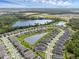Scenic aerial shot of a residential community featuring lake views and manicured green spaces at 17860 Passionflower Cir, Clermont, FL 34714