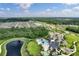 An aerial view of a Primary planned community with a pool, clubhouse, and playground at 17860 Passionflower Cir, Clermont, FL 34714