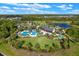 Aerial photo of community amenities: pools, clubhouse, and park areas in a residential setting at 17860 Passionflower Cir, Clermont, FL 34714