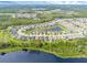 An aerial view highlights the community's layout with houses surrounding a serene lake at 17860 Passionflower Cir, Clermont, FL 34714