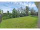 Fenced backyard with large manicured lawn at 17860 Passionflower Cir, Clermont, FL 34714