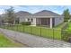 This backyard features a screened lanai, secure black metal fence, and a well-maintained green lawn at 17860 Passionflower Cir, Clermont, FL 34714