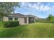 Landscaped backyard with lush green lawn and patio at 17860 Passionflower Cir, Clermont, FL 34714