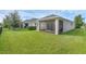 The home's screened-in patio and grassy lawn are perfect for the outdoors at 17860 Passionflower Cir, Clermont, FL 34714