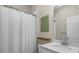 The bathroom showcases a shower with white curtain and a modern vanity at 17860 Passionflower Cir, Clermont, FL 34714