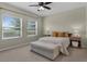 Comfortable bedroom with natural light features carpeted floors and neutral-colored walls at 17860 Passionflower Cir, Clermont, FL 34714