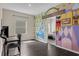 This bedroom has brightly colored art and an adjacent bedroom is viewed through the doorway at 17860 Passionflower Cir, Clermont, FL 34714