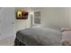 Neutral bedroom with a window, wall-mounted TV and a comfortable bed at 17860 Passionflower Cir, Clermont, FL 34714
