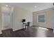 This bedroom features wood flooring, a bathroom, a large window, and a small computer desk at 17860 Passionflower Cir, Clermont, FL 34714