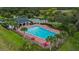 Outdoor community pool featuring lounge chairs, palm trees, and landscaped surroundings for relaxation at 17860 Passionflower Cir, Clermont, FL 34714