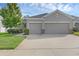 Charming home featuring a wide driveway, three-car garage, and well-maintained landscaping at 17860 Passionflower Cir, Clermont, FL 34714