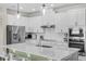 Close up view of the quartz countertop and stainless steel appliances in the kitchen area at 17860 Passionflower Cir, Clermont, FL 34714