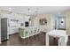 Bright kitchen featuring white cabinets, stainless steel appliances, a green island, and a breakfast bar seating four at 17860 Passionflower Cir, Clermont, FL 34714