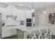 Bright kitchen with white cabinets, subway tile, a large island, and stainless steel appliances at 17860 Passionflower Cir, Clermont, FL 34714