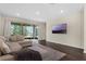 A comfortable living room with hardwood floors has a large sliding glass door leading to an outdoor space at 17860 Passionflower Cir, Clermont, FL 34714