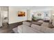 Open-concept living room features a sectional sofa and flows into the kitchen with bar seating at 17860 Passionflower Cir, Clermont, FL 34714