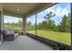 Screened patio featuring outdoor seating overlooking a well-maintained yard at 17860 Passionflower Cir, Clermont, FL 34714