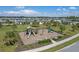 Community playground with various play structures, benches, and landscaping, set against a backdrop of neighborhood homes at 17860 Passionflower Cir, Clermont, FL 34714