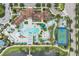 Stunning aerial view of the community pool, clubhouse, lazy river, sports court, and waterfront amenities at 1935 Majorca Dr, Kissimmee, FL 34747