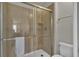 Tiled shower stall with glass door, toilet, and towel bar enhance this bathroom at 1935 Majorca Dr, Kissimmee, FL 34747
