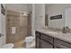 Bathroom featuring a walk-in shower with glass door and vanity with granite counters at 1935 Majorca Dr, Kissimmee, FL 34747