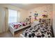 Themed bedroom with twin beds, cartoon character decor, and playful wallpaper at 1935 Majorca Dr, Kissimmee, FL 34747