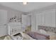 Bedroom featuring a crib and daybed with stylish decor at 1935 Majorca Dr, Kissimmee, FL 34747