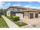 Exterior view of a two-story house with a private screened in patio and two-car garage at 1935 Majorca Dr, Kissimmee, FL 34747