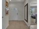 Welcoming foyer with neutral tile flooring, art decoration and a view leading into the bedroom at 1935 Majorca Dr, Kissimmee, FL 34747