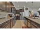 Stylish kitchen features granite counters, stainless steel appliances, dark wood cabinets and tile floors at 1935 Majorca Dr, Kissimmee, FL 34747