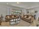 Bright living room with tile floors, comfortable seating, and sliding glass doors to the outdoor patio at 1935 Majorca Dr, Kissimmee, FL 34747