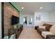 Cozy loft area featuring a brick accent wall, a TV, and comfortable seating at 1935 Majorca Dr, Kissimmee, FL 34747