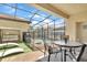 Outdoor pool area featuring a screened lanai, dining table, and lounge furniture at 1935 Majorca Dr, Kissimmee, FL 34747