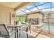The outdoor pool is surrounded by a screened lanai with dining and lounging areas at 1935 Majorca Dr, Kissimmee, FL 34747