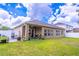 Back of house with a covered patio and green yard at 2031 Gloria Oak Ct, Orlando, FL 32820