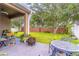 Large backyard with a patio, furniture, and mature landscaping at 2031 Gloria Oak Ct, Orlando, FL 32820
