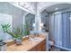 Well-lit bathroom with an expansive mirror, unique light fixture, and decorative accents at 2031 Gloria Oak Ct, Orlando, FL 32820