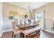 Elegant dining room with a rustic table, chandelier, and decorative wall hangings at 2031 Gloria Oak Ct, Orlando, FL 32820