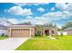 Charming one-story home with a two-car garage and manicured lawn at 2031 Gloria Oak Ct, Orlando, FL 32820