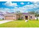 Charming single-story home with well-manicured lawn and beautiful landscaping at 2031 Gloria Oak Ct, Orlando, FL 32820