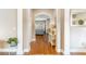Inviting hallway with hardwood floors and decorative archways leading to the living areas at 2031 Gloria Oak Ct, Orlando, FL 32820