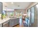 Bright kitchen with stainless steel appliances, hardwood floors, and views of the living room and backyard at 2031 Gloria Oak Ct, Orlando, FL 32820