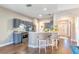 Open kitchen with counter seating, stainless appliances, and neutral countertops at 2031 Gloria Oak Ct, Orlando, FL 32820
