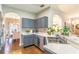 Well-lit kitchen featuring stainless steel appliances, gray cabinets, and a view into the dining room at 2031 Gloria Oak Ct, Orlando, FL 32820